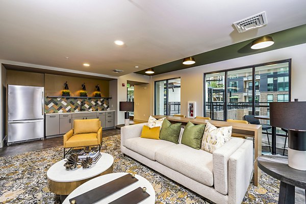 Clubhouse with modern design and comfortable seating at The Aston at Town Center Apartments, featuring elegant interiors for social gatherings