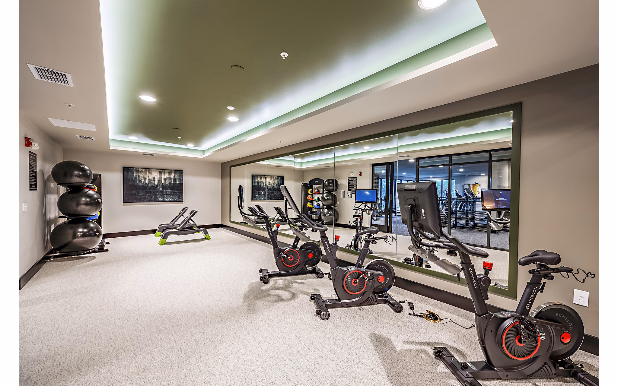 Modern spin studio featuring advanced stationary bikes at The Aston at Town Center Apartments