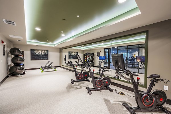 Modern spin studio featuring advanced stationary bikes at The Aston at Town Center Apartments