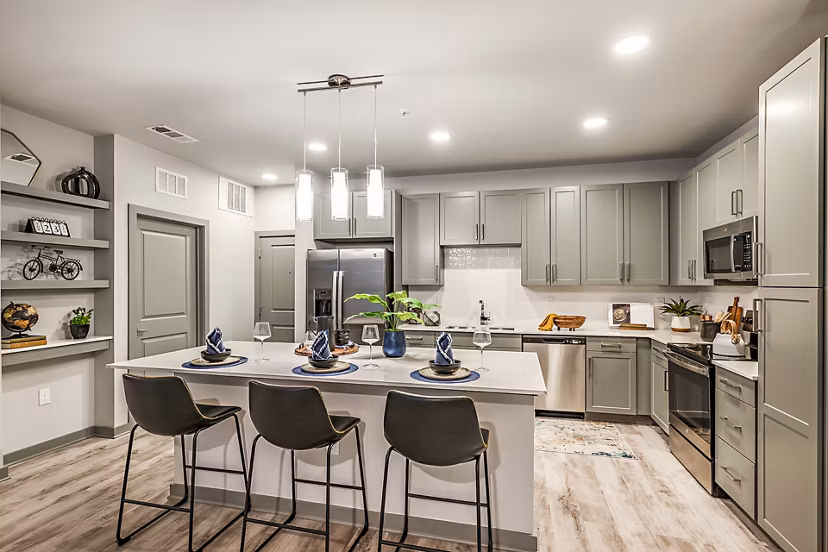 Modern kitchen featuring sleek countertops and stainless steel appliances at The Aston at Town Center Apartments