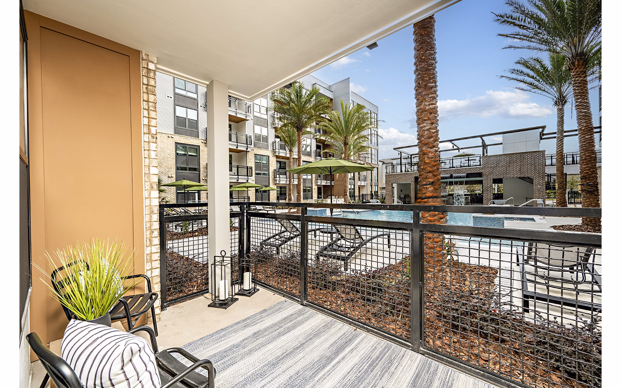 Modern patio balcony with outdoor furniture at The Aston at Town Center Apartments, offering luxury living in a vibrant community