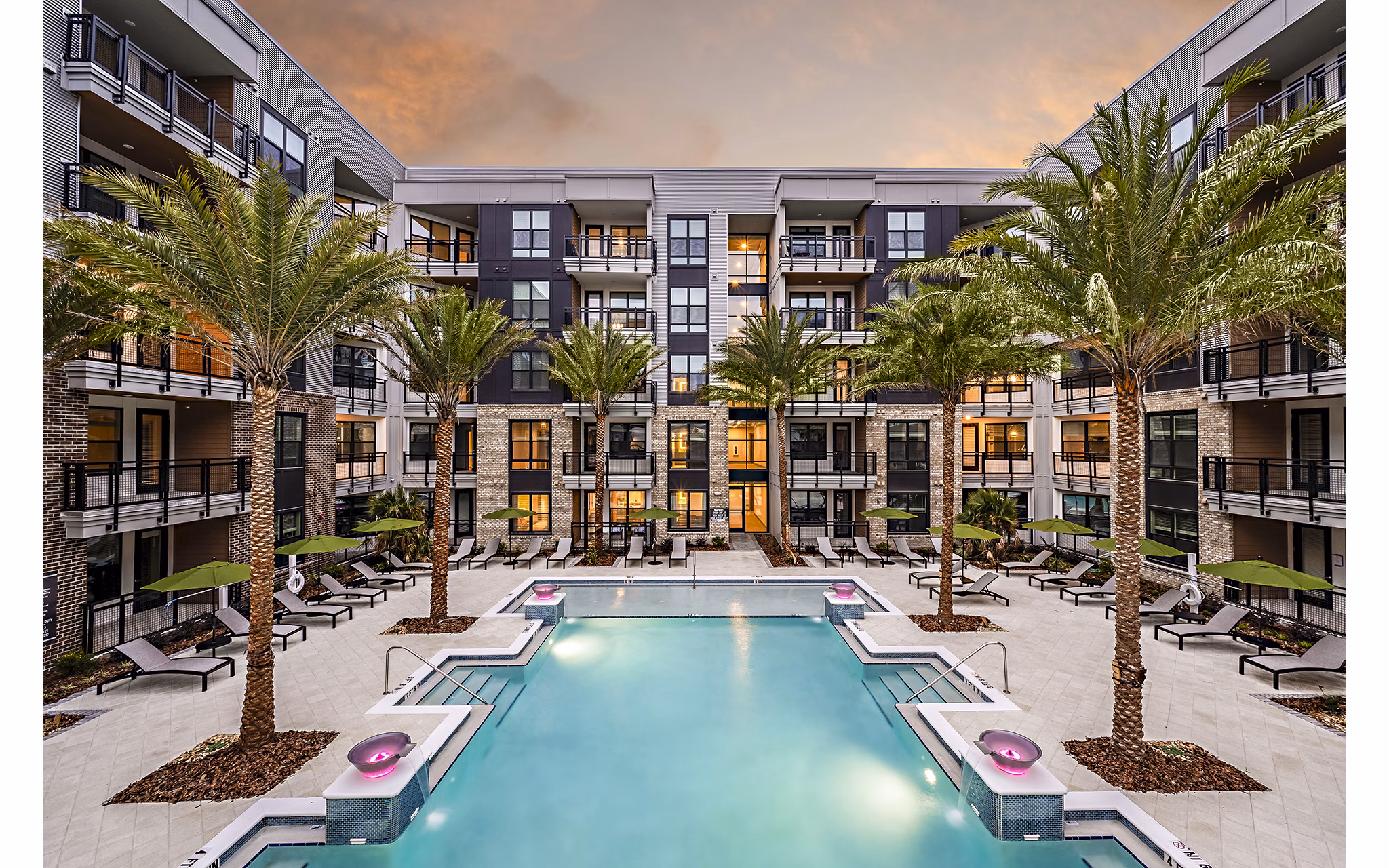 Expansive pool area with lounge chairs at The Aston at Town Center Apartments, a luxury oasis for relaxation and recreation