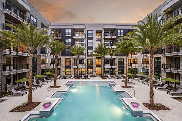 Expansive pool area with lounge chairs at The Aston at Town Center Apartments, a luxury oasis for relaxation and recreation