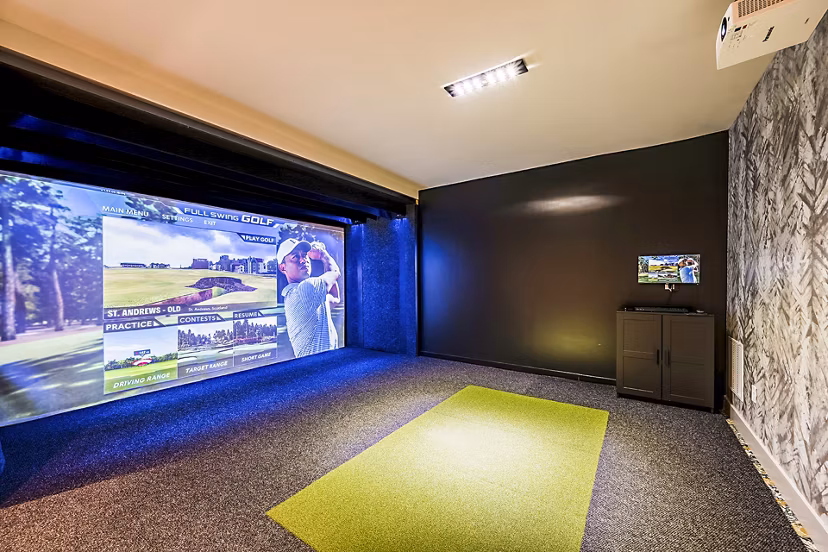 Modern virtual driving range at The Aston at Town Center Apartments, offering high-tech golfing experience for residents
