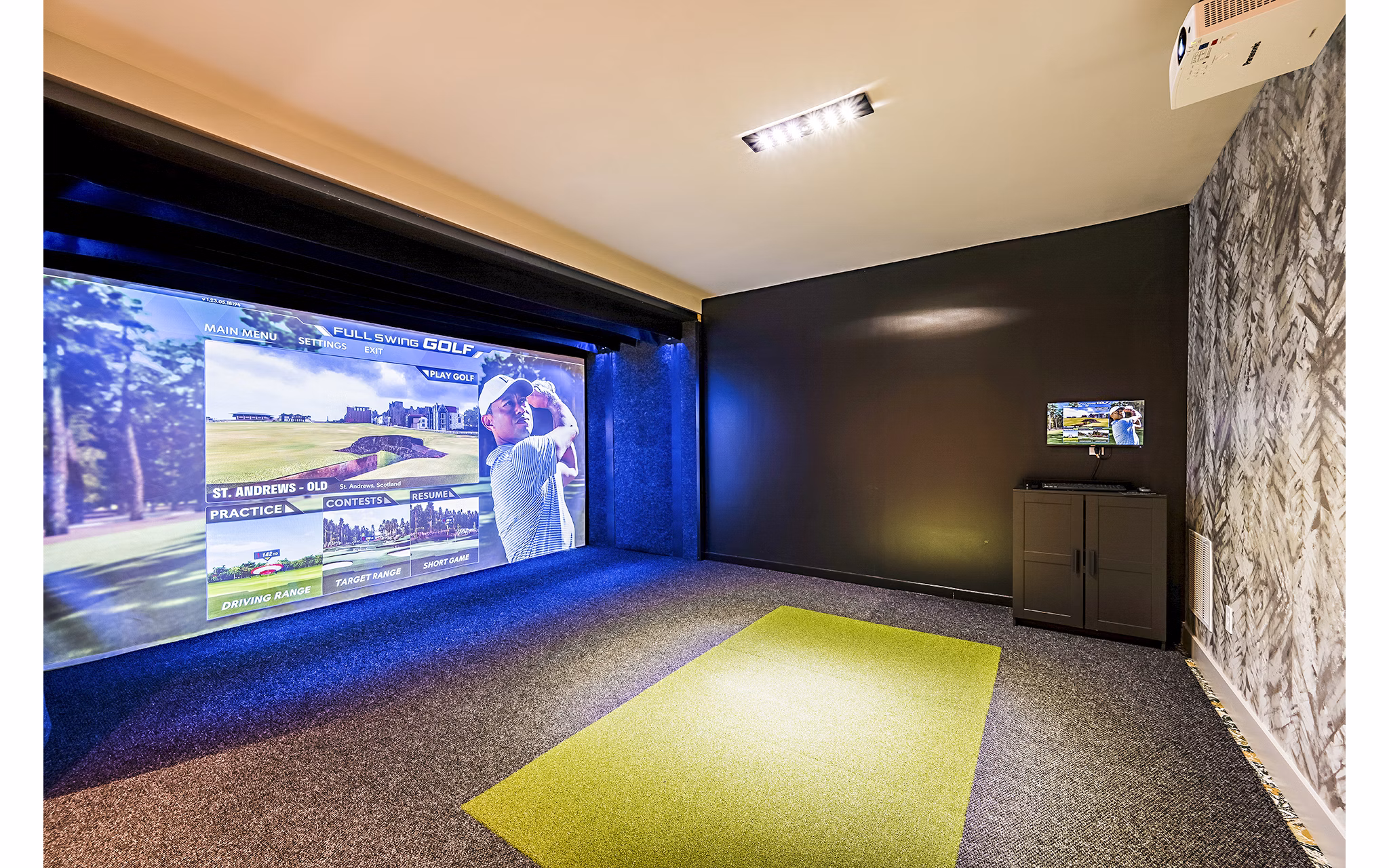 Modern virtual driving range at The Aston at Town Center Apartments, offering high-tech golfing experience for residents