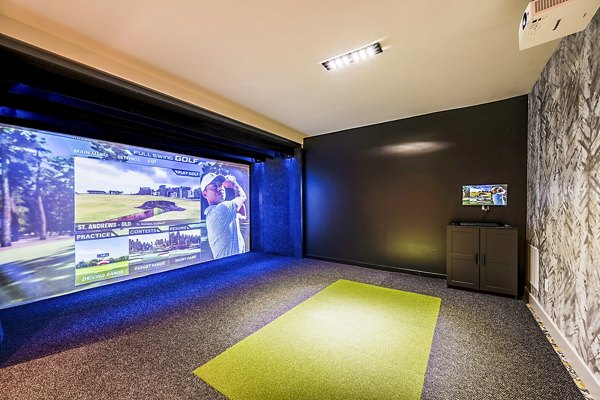 Modern virtual driving range at The Aston at Town Center Apartments, offering high-tech golfing experience for residents