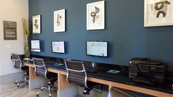 Business center with modern workstations at Palms at Cinco Ranch Apartments, ideal for remote work and meetings