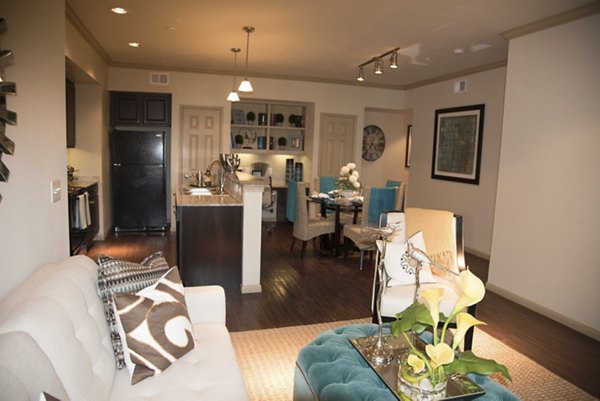 Spacious living room with modern decor and natural light at Palms at Cinco Ranch Apartments