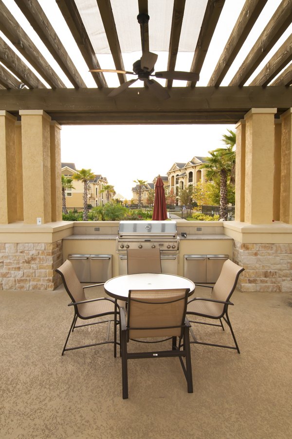 Outdoor grill area with modern appliances at Palms at Cinco Ranch Apartments, perfect for entertaining and social gatherings