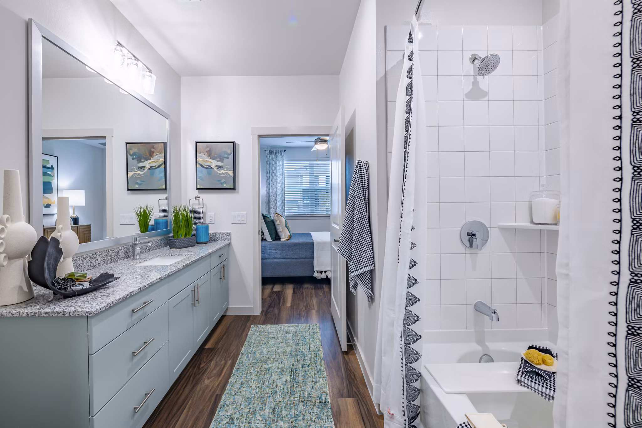 Modern bathroom featuring sleek fixtures and large mirror at Prose Stoneridge Apartments