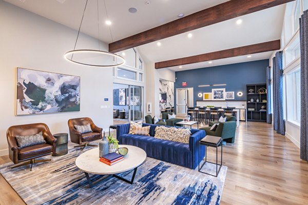 Clubhouse with modern furnishings and lounge seating at Prose Stoneridge Apartments