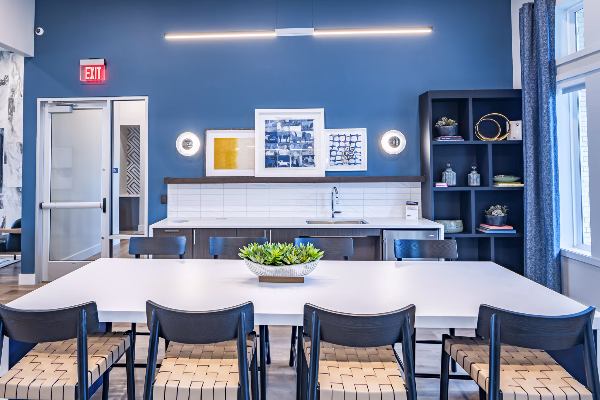 Clubhouse at Prose Stoneridge Apartments: Modern communal space with lounge seating and entertainment area for residents