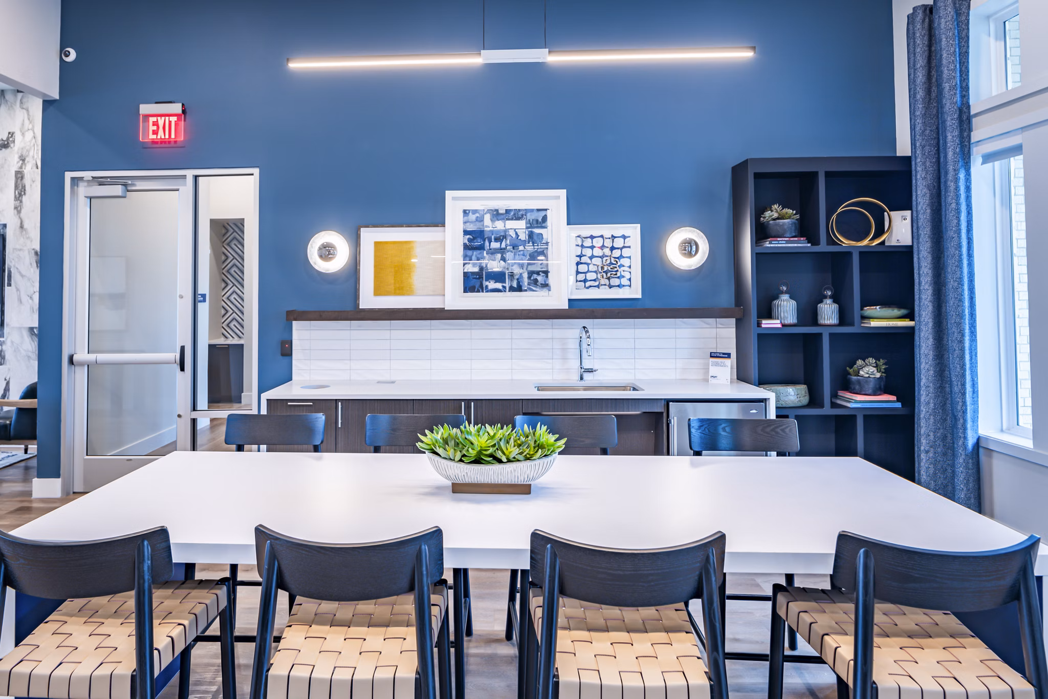 Clubhouse at Prose Stoneridge Apartments: Modern communal space with lounge seating and entertainment area for residents