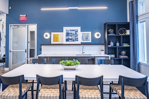 Clubhouse at Prose Stoneridge Apartments: Modern communal space with lounge seating and entertainment area for residents