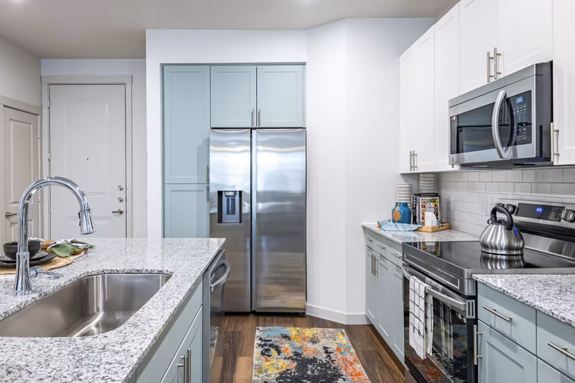 Modern kitchen with stainless steel appliances at Prose Stoneridge Apartments