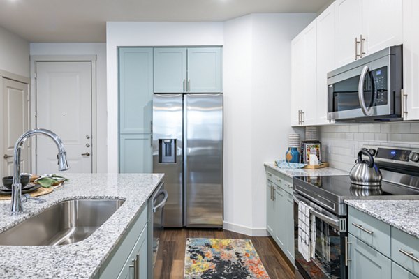 Modern kitchen with stainless steel appliances at Prose Stoneridge Apartments