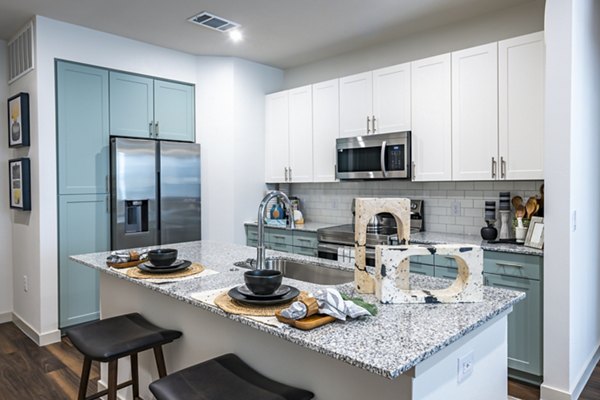 Modern kitchen with stainless steel appliances at Prose Stoneridge Apartments
