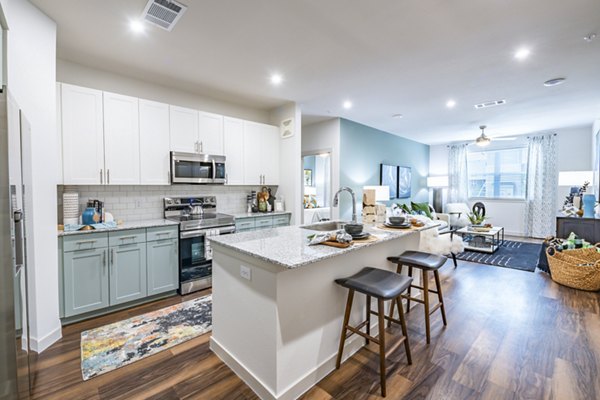 Modern kitchen with stainless steel appliances at Prose Stoneridge Apartments, ideal for cooking and entertaining in a luxury setting