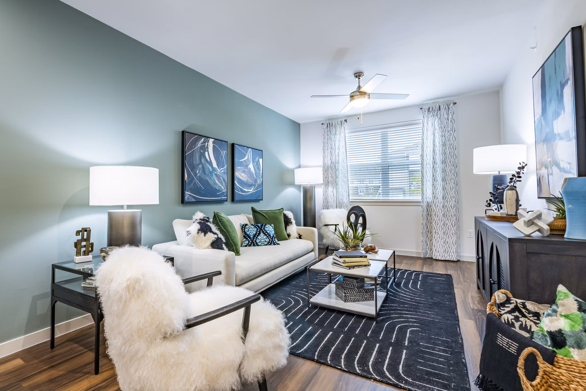 Spacious living room with modern decor and large windows at Prose Stoneridge Apartments