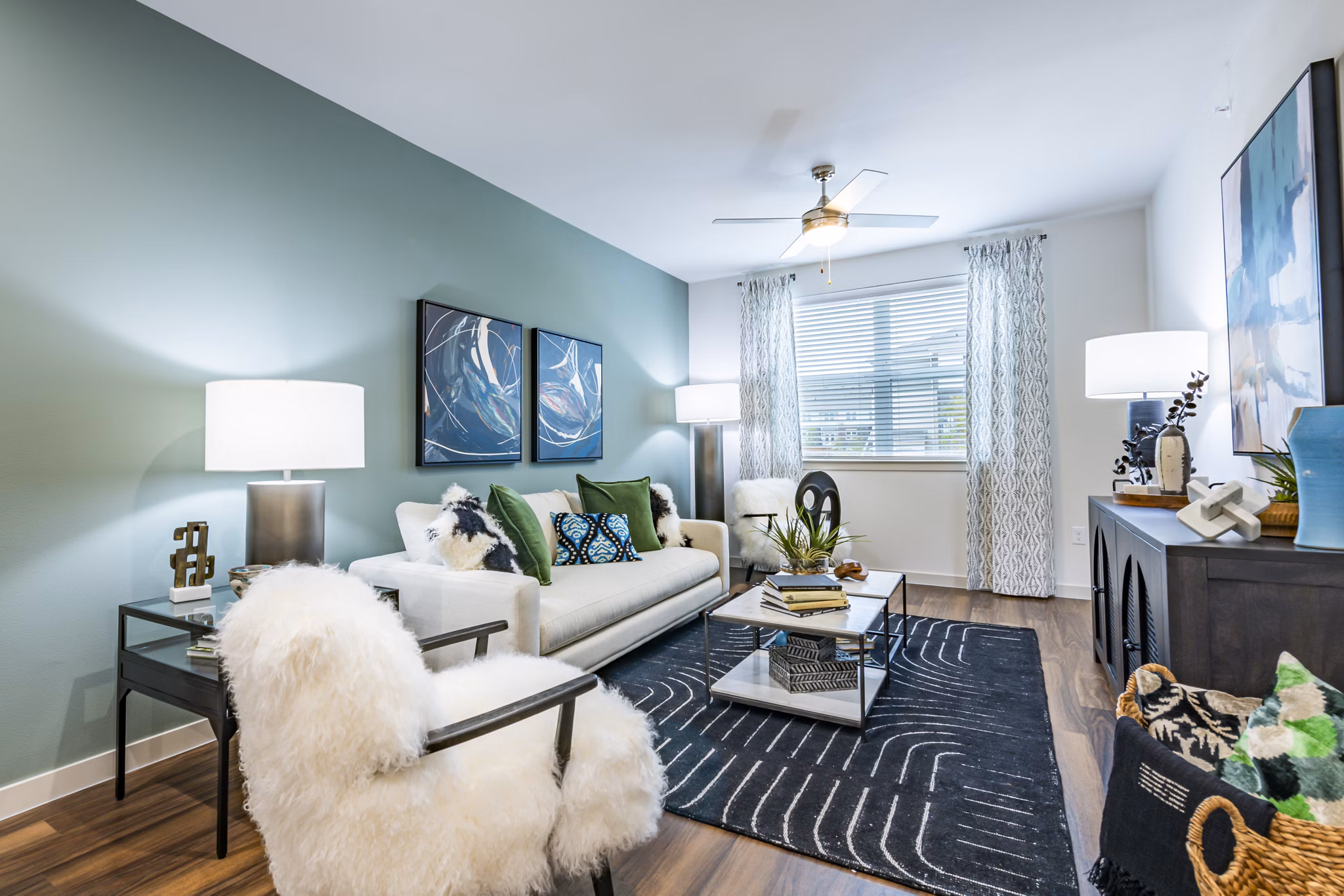 Spacious living room with modern decor and large windows at Prose Stoneridge Apartments