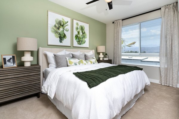 Modern bedroom with plush bedding at Avenida Palm Desert Apartments, offering luxury living spaces in a premier California location