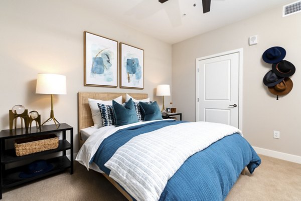 Cozy bedroom with stylish decor at Avenida Palm Desert Apartments, offering luxury living in a tranquil setting