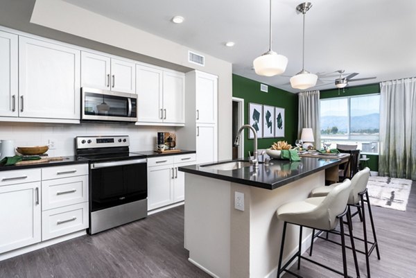 Kitchen featuring modern stainless steel appliances at Avenida Palm Desert Apartments