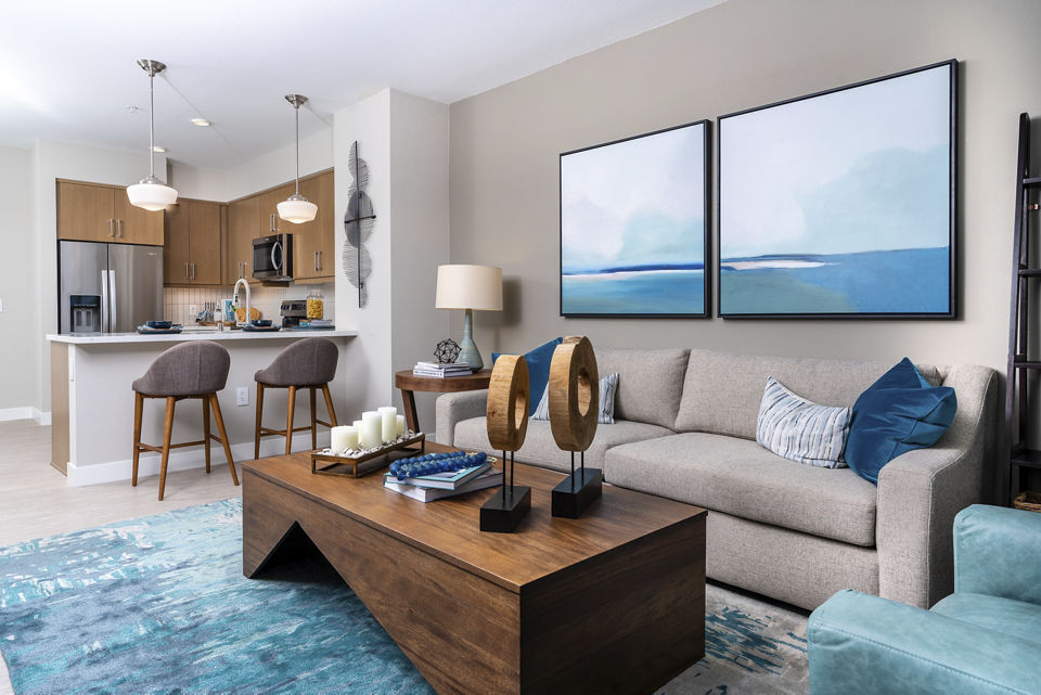 Spacious living room featuring modern decor and natural light at Avenida Palm Desert Apartments