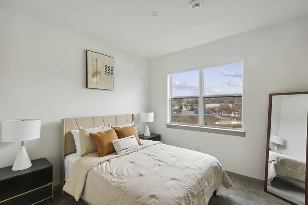 Modern bedroom with stylish decor at The Foundmore Apartments: luxury living by Greystar in a premier location