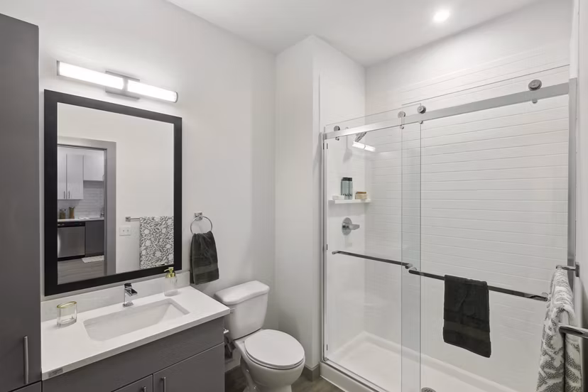 Modern bathroom with sleek finishes at The Foundmore Apartments, featuring elegant vanity and spacious shower