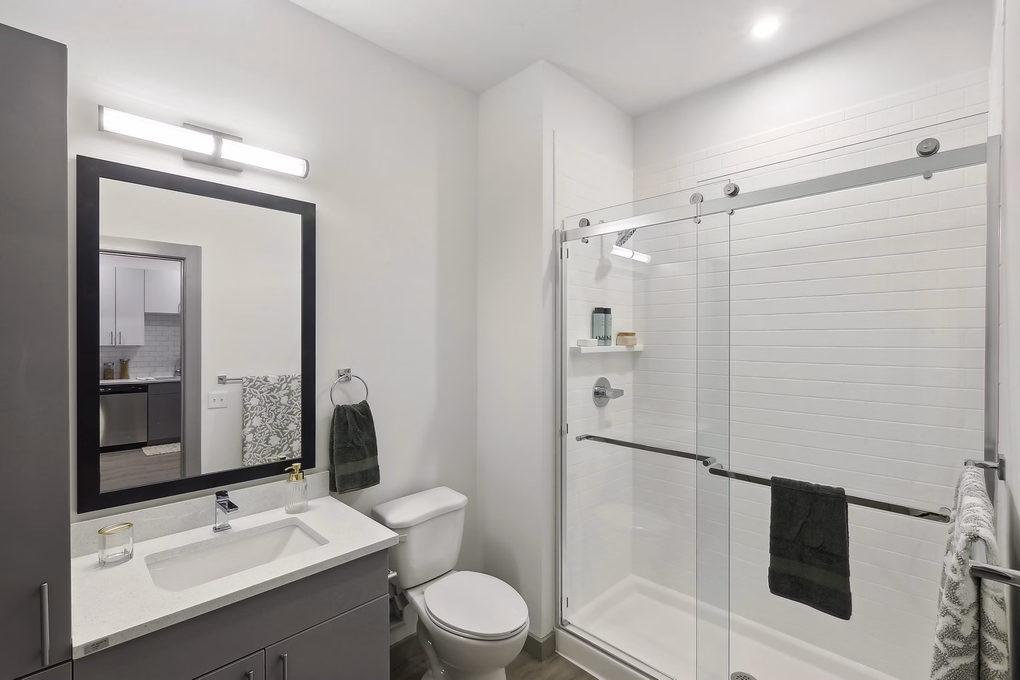 Modern bathroom with sleek finishes at The Foundmore Apartments, featuring elegant vanity and spacious shower