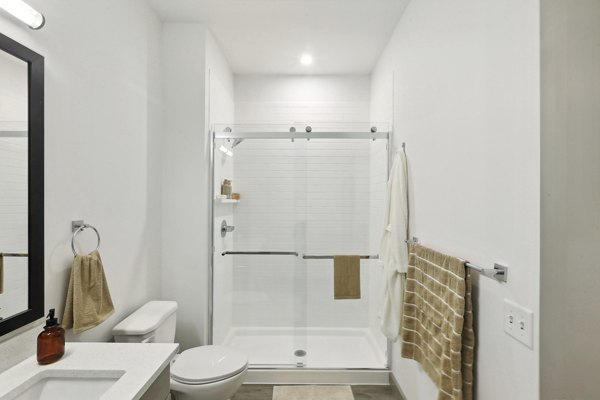 Elegant bathroom with marble countertops at The Foundmore Apartments, a luxury apartment community by
