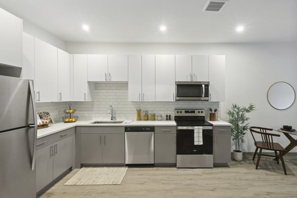 Modern kitchen with stainless steel appliances at The Foundmore Apartments