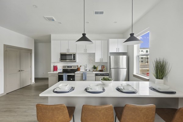 Modern kitchen with sleek countertops and stainless steel appliances at The Foundmore Apartments
