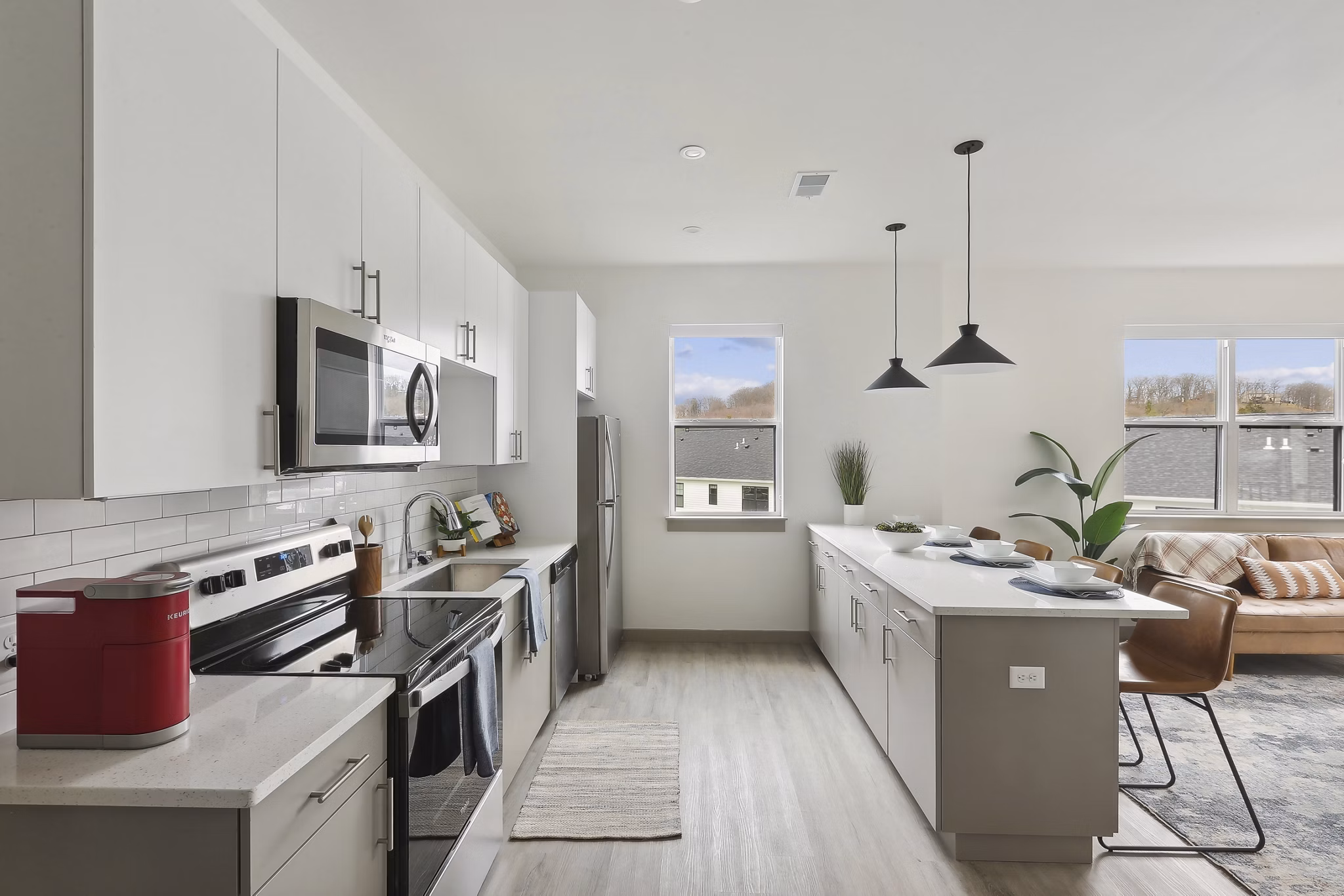 Modern kitchen with stainless steel appliances in The Foundmore Apartments, luxury living by Greystar
