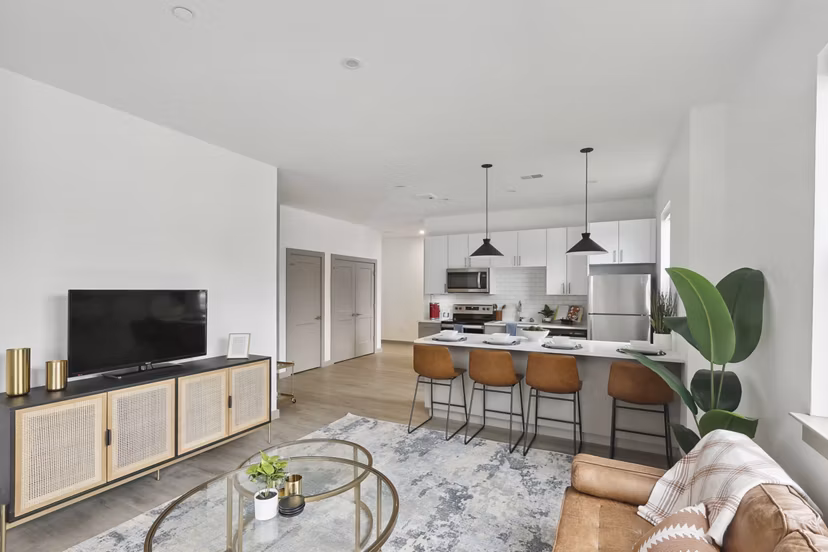 Modern living room with sleek furniture and natural light at The Foundmore Apartments