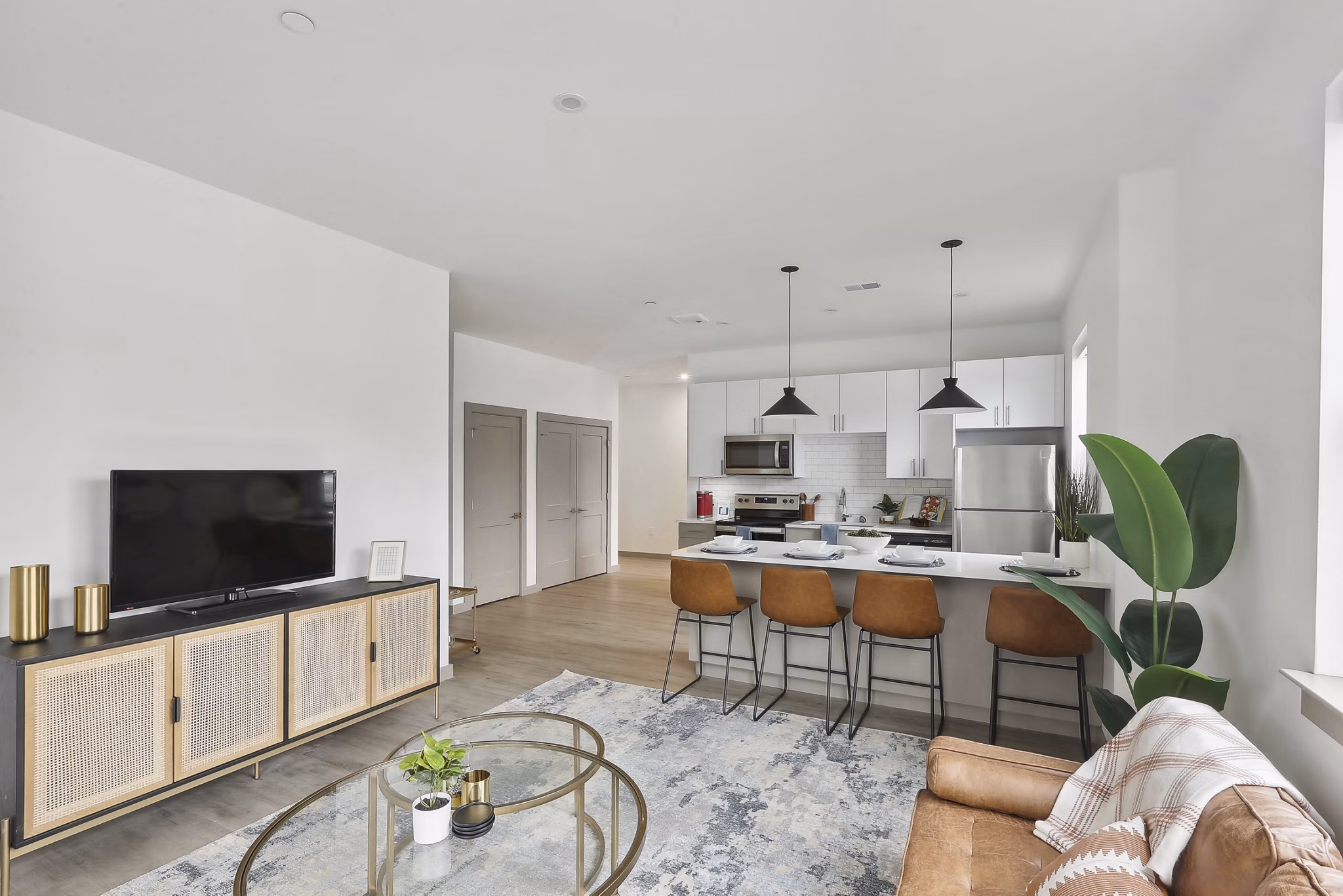Modern living room with sleek furniture and natural light at The Foundmore Apartments