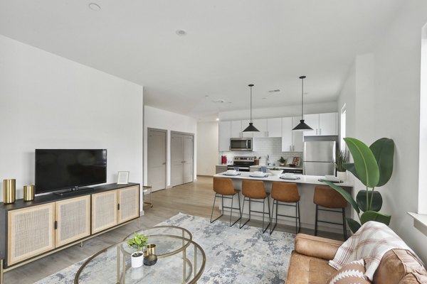 Modern living room with sleek furniture and natural light at The Foundmore Apartments