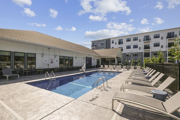 Resort-style pool surrounded by lush landscaping at The Foundmore Apartments offering luxury living