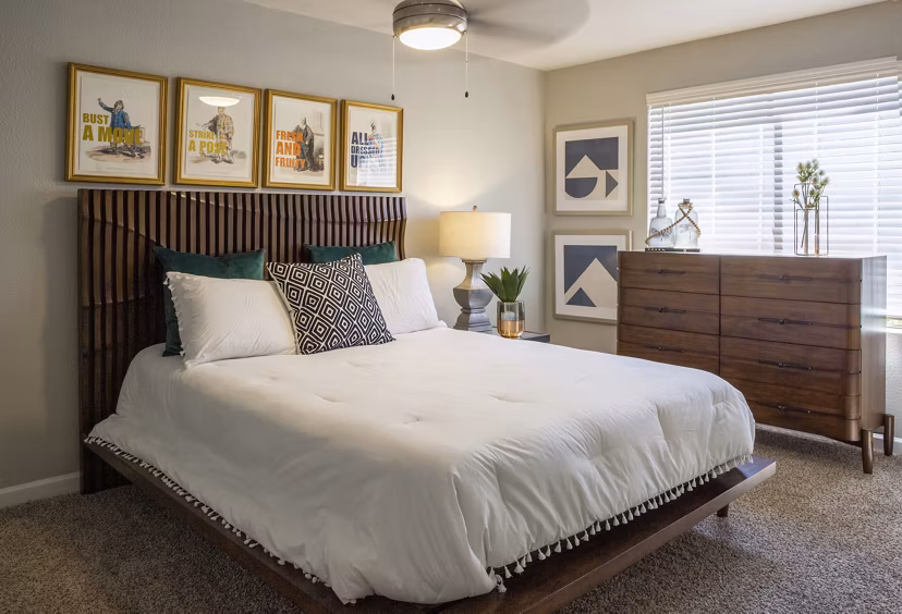 Bedroom featuring modern decor and large windows at The Julia Apartments