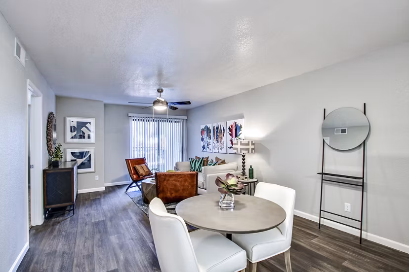Modern living and dining area featuring a round table and artwork in luxury apartment