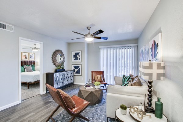 Modern living room with stylish furniture and a view into the bedroom in luxury apartments