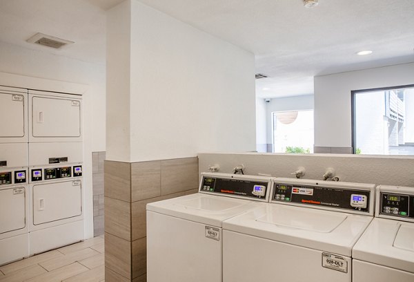 Modern laundry facility with high-efficiency appliances at The Julia Apartments, offering convenience and style for luxury living