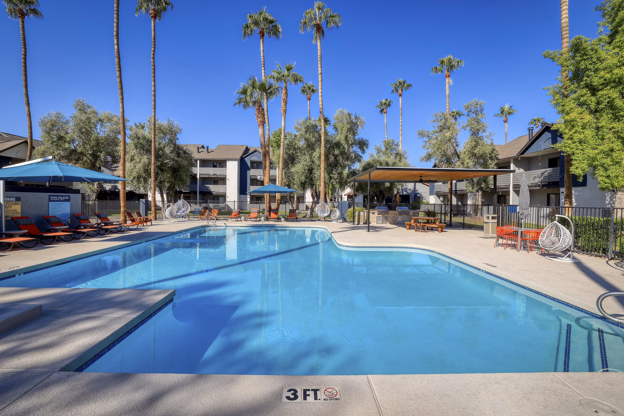 Poolside luxury at The Julia Apartments, featuring modern pool amenities and elegant outdoor seating, offering a relaxing retreat for residents