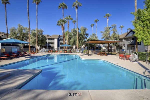 Poolside luxury at The Julia Apartments, featuring modern pool amenities and elegant outdoor seating, offering a relaxing retreat for residents