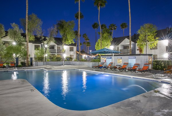 Outdoor pool with lounge chairs at The Julia Apartments offering luxury living