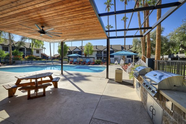 Outdoor barbecue area with modern grills at The Julia Apartments, a luxury property offering premium outdoor amenities