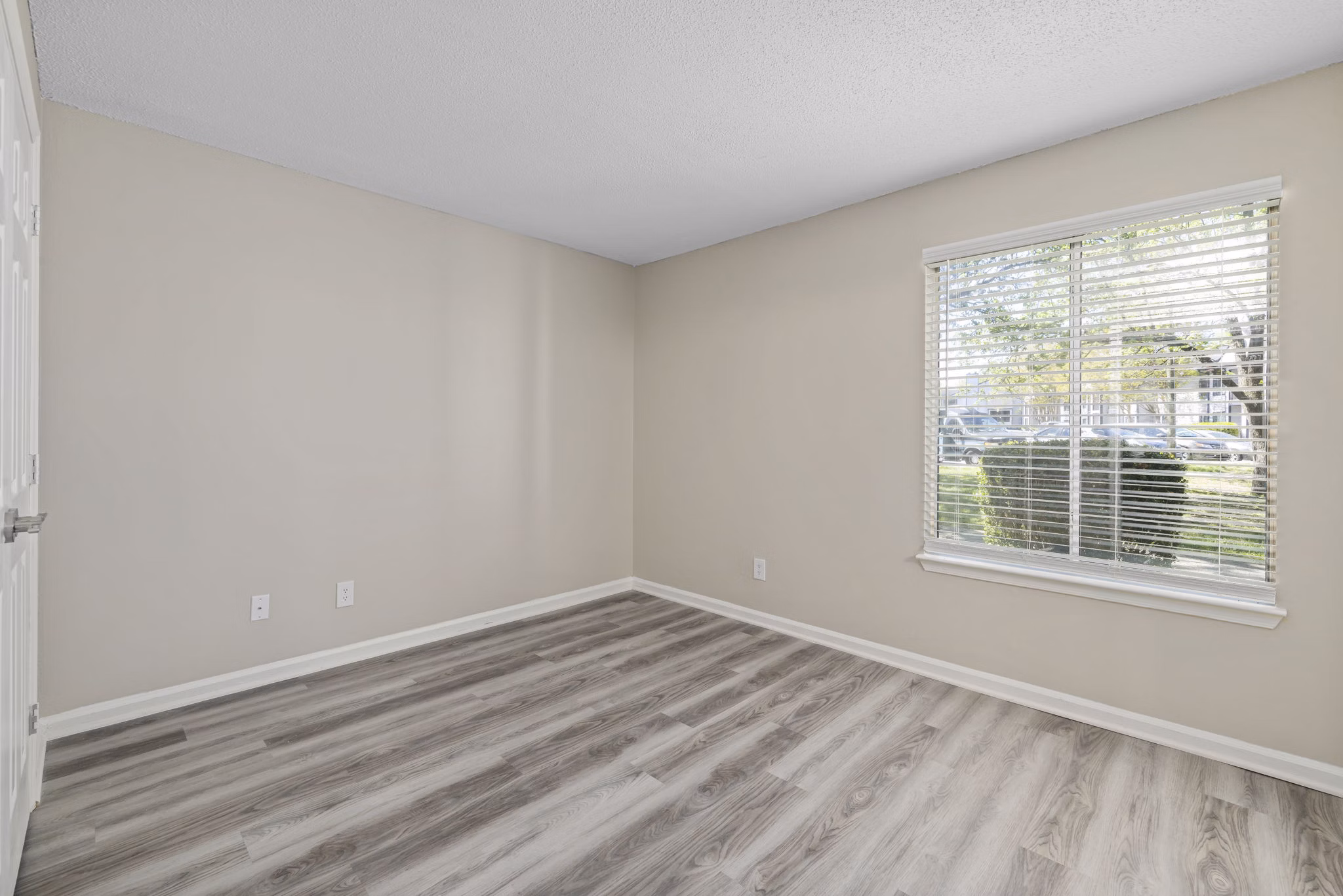 Cozy bedroom with modern furniture and decor at Madison at Adams Farm Apartments
