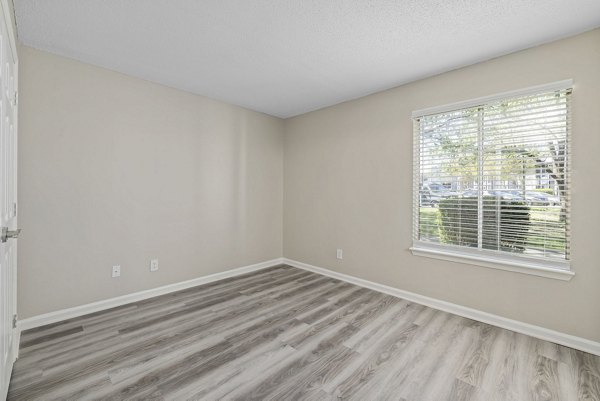 Cozy bedroom with modern furniture and decor at Madison at Adams Farm Apartments