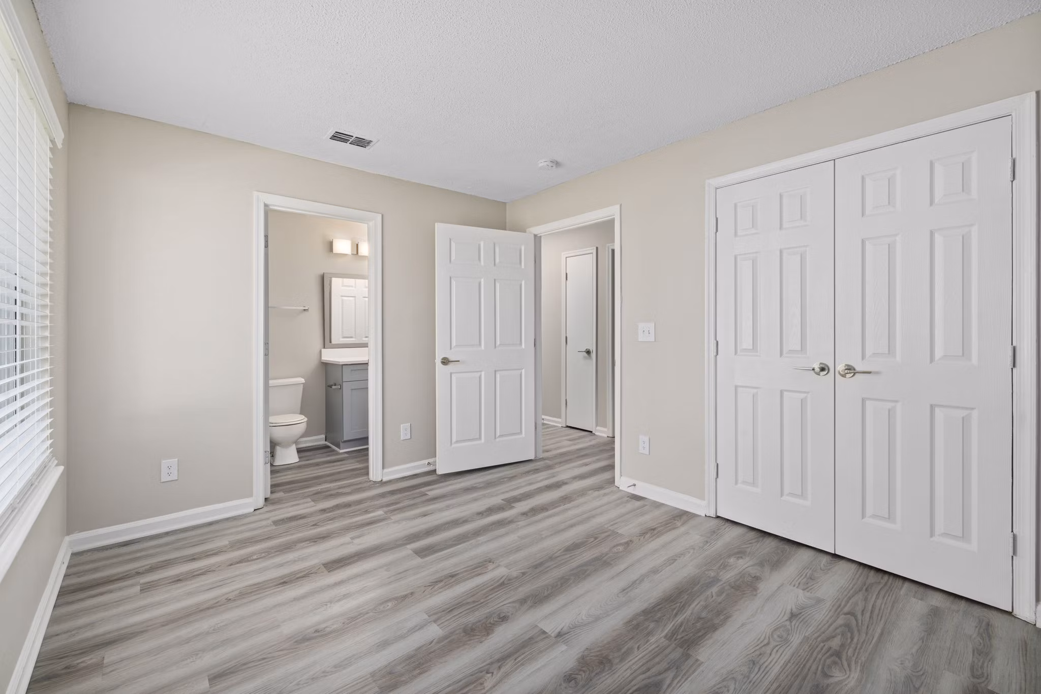 Cozy bedroom featuring elegant dÃ©cor at Madison at Adams Farm Apartments